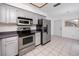Functional kitchen with stainless steel appliances, white cabinets, and plenty of countertop space at 3454 Hillmoor Dr, Palm Harbor, FL 34685