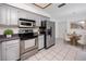Functional kitchen featuring stainless steel appliances, updated cabinets, and adjacent breakfast nook for casual dining at 3454 Hillmoor Dr, Palm Harbor, FL 34685