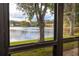 Amazing view of the lake and surrounding landscape through large, bright windows at 3454 Hillmoor Dr, Palm Harbor, FL 34685