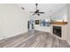 Open living space with a fireplace, ceiling fan, and sliding glass doors to the outside at 3454 Hillmoor Dr, Palm Harbor, FL 34685