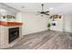 Inviting living room featuring a cozy fireplace, modern flooring, and lots of open space at 3454 Hillmoor Dr, Palm Harbor, FL 34685