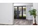 Living room featuring wood floors and view of lake with beautiful landscaping at 3454 Hillmoor Dr, Palm Harbor, FL 34685
