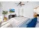 Serene main bedroom boasts ample natural light, a ceiling fan, and convenient access to an ensuite bathroom at 3454 Hillmoor Dr, Palm Harbor, FL 34685