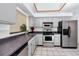Modern kitchen with stainless steel appliances and grey cabinets at 3454 Hillmoor Dr, Palm Harbor, FL 34685
