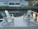 An outdoor seating area on the dock with four Adirondack chairs facing the water at 4086 13Th Ne Ln, St Petersburg, FL 33703