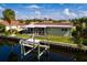 Waterfront home features a screened lanai, boat lift, and lush tropical landscaping at 4086 13Th Ne Ln, St Petersburg, FL 33703