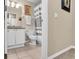 Cozy bathroom featuring a vanity, toilet, and shower with neutral tones and tiled flooring at 411 S Fremont Ave # B, Tampa, FL 33606