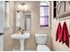 Cozy powder room featuring a pedestal sink, and a purple window shade at 411 S Fremont Ave # B, Tampa, FL 33606