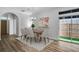 Dining room with modern chandelier, table, and chairs, and a sliding door at 411 S Fremont Ave # B, Tampa, FL 33606