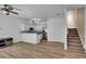Bright open floor plan with wood floors connecting the kitchen to the staircase at 411 S Fremont Ave # B, Tampa, FL 33606