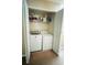 Practical laundry room with a washer, dryer, and storage shelving at 411 S Fremont Ave # B, Tampa, FL 33606