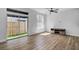 Living area featuring wood floors, a ceiling fan, and sliding glass doors to the backyard at 411 S Fremont Ave # B, Tampa, FL 33606