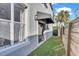 Side yard featuring a wooden fence and artificial grass at 411 S Fremont Ave # B, Tampa, FL 33606