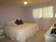 Main bedroom with a king-size bed, white dresser, and light purple walls at 6000 20Th N St # 129, St Petersburg, FL 33714