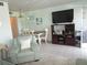 Dining area with white table and chairs, and a view into the kitchen at 6000 20Th N St # 129, St Petersburg, FL 33714