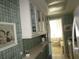Kitchen with white cabinets and glass-front upper cabinets at 6000 20Th N St # 129, St Petersburg, FL 33714