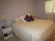 Bright bedroom with a queen-size bed and nightstand at 6000 20Th N St # 129, St Petersburg, FL 33714