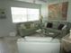 Living room with light green leather sofas, coffee table, and large artwork at 6000 20Th N St # 129, St Petersburg, FL 33714