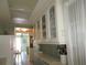 Kitchen with white cabinets and view to dining area at 6000 20Th N St # 129, St Petersburg, FL 33714