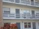 Exterior view of a light-grey building with multiple balconies and individual apartment numbers at 6000 20Th N St # 129, St Petersburg, FL 33714