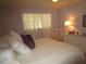 Main bedroom with a king-size bed, white dresser, and light purple walls at 6000 20Th N St # 129, St Petersburg, FL 33714