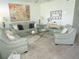 Living room with light green leather sofas, coffee table, and large artwork at 6000 20Th N St # 129, St Petersburg, FL 33714