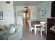 Dining area with white table and chairs and a view into the kitchen at 6000 20Th N St # 129, St Petersburg, FL 33714