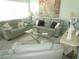 Living room with light green leather sofas, coffee table, and large artwork at 6000 20Th N St # 129, St Petersburg, FL 33714