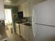 Kitchen with white cabinets, gas stove, and microwave at 6000 20Th N St # 129, St Petersburg, FL 33714