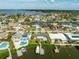 Aerial view of the house, neighborhood, and waterfront with boats at 7872 1St S Ave, St Petersburg, FL 33707