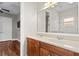 Double vanity bathroom with a large mirror and hardwood floors at 8306 Windsor Bluff Dr, Tampa, FL 33647