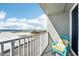 Beachfront balcony view with a chair, offering stunning ocean and boardwalk scenery at 9980 Gulf Blvd # 207, Treasure Island, FL 33706