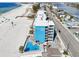 Aerial view showcasing hotel, pool, and beach; ideal for a relaxing vacation at 9980 Gulf Blvd # 207, Treasure Island, FL 33706