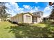 Home features a screened patio and grassy backyard at 2468 Kensington Greens Dr, Sun City Center, FL 33573