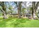 House exterior with large trees and grassy yard at 33137 Cercelia Rd, Dade City, FL 33523