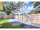 Large backyard with wooden fence, providing privacy and space for outdoor activities at 33137 Cercelia Rd, Dade City, FL 33523