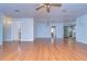Living room with wood floors and a view into the kitchen and bathroom at 33137 Cercelia Rd, Dade City, FL 33523