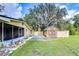 Backyard with screened patio, shed and large oak tree at 33137 Cercelia Rd, Dade City, FL 33523