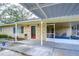 Home features a covered entryway and screened porch at 33137 Cercelia Rd, Dade City, FL 33523