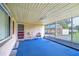 Spacious screened porch with blue flooring and outdoor seating at 33137 Cercelia Rd, Dade City, FL 33523
