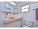 Retro bathroom with pink tile, vanity, and shower at 33137 Cercelia Rd, Dade City, FL 33523