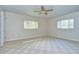 Bedroom with carpet, ceiling fan and two windows at 33137 Cercelia Rd, Dade City, FL 33523