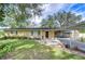 House exterior featuring a carport and well-maintained lawn at 33137 Cercelia Rd, Dade City, FL 33523