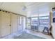 Bright screened porch with leafy green rug and rocking chair at 33137 Cercelia Rd, Dade City, FL 33523