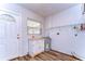 Laundry room with white cabinets, shelving, and vinyl flooring at 33137 Cercelia Rd, Dade City, FL 33523