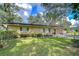 House exterior with manicured lawn and landscaping at 33137 Cercelia Rd, Dade City, FL 33523
