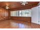 Sunroom with wood walls and floors and large windows at 33137 Cercelia Rd, Dade City, FL 33523
