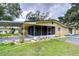 Ranch-style home with carport, screened porch, and landscaped yard at 33137 Cercelia Rd, Dade City, FL 33523