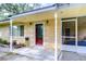 House with a red front door and covered porch at 33137 Cercelia Rd, Dade City, FL 33523
