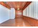 Sunroom with wood walls and floors and large windows at 33137 Cercelia Rd, Dade City, FL 33523